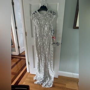 White dress with lace detail. Wedding style like gown that’s never been worn